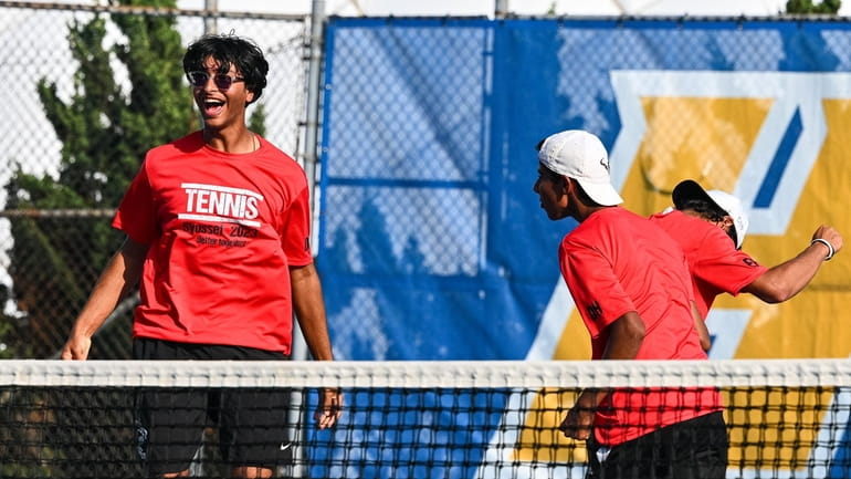 Syosset doubles team Shiu Chadha (at net) and Aayan Mehta react after...