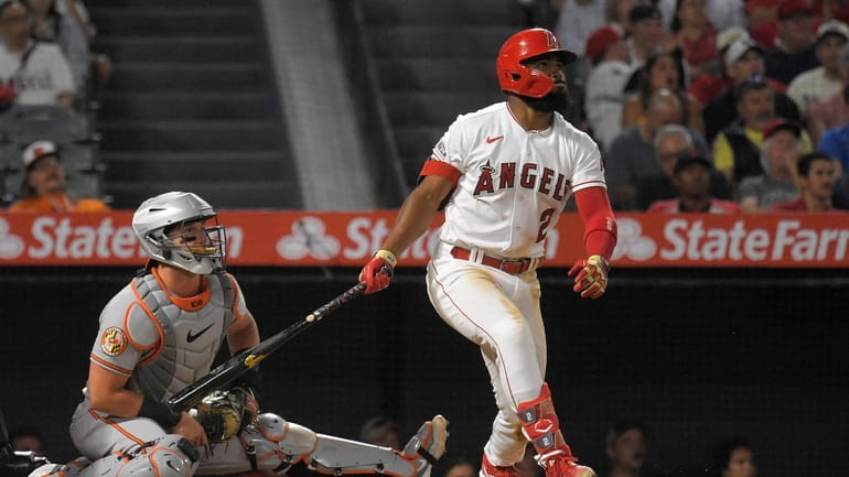 Los Angeles Angels' Luis Rengifo, right, heads to first for...
