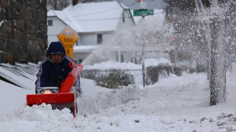 Residents clear snow on Willis Avenue in Mineola. (Feb. 9,...
