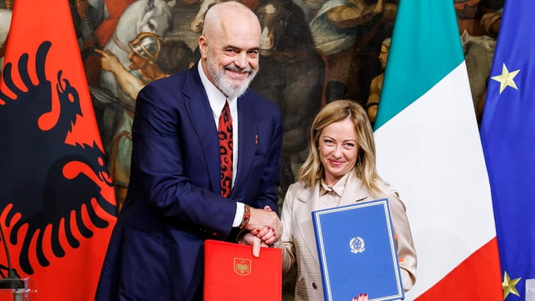 Italy's Premier Giorgia Meloni, right, and Albania's Prime Minister Edi...