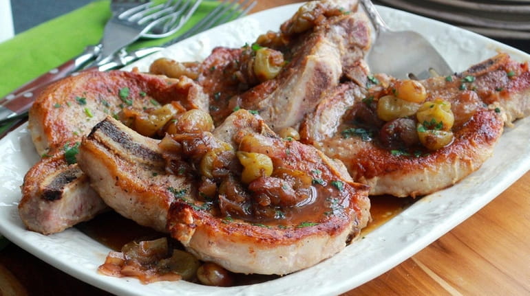 Pan-seared pork chops topped with a chunky relish made with...