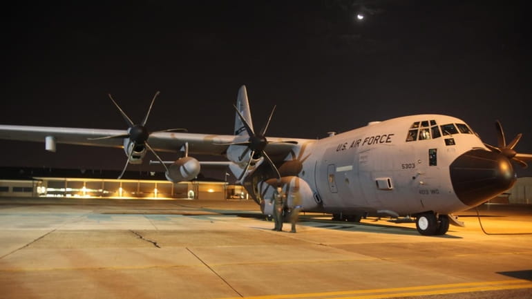 The crew prepares the WC-130J aircraft to fly into Hurricane...
