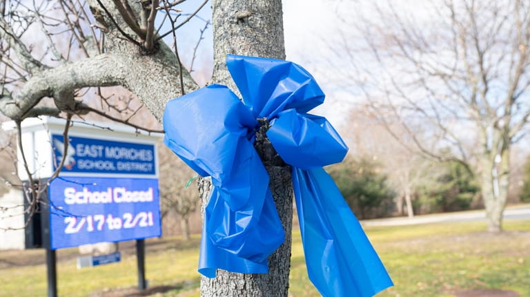 Blue ribbons are on posts, storefronts, homes and mailboxes throughout...