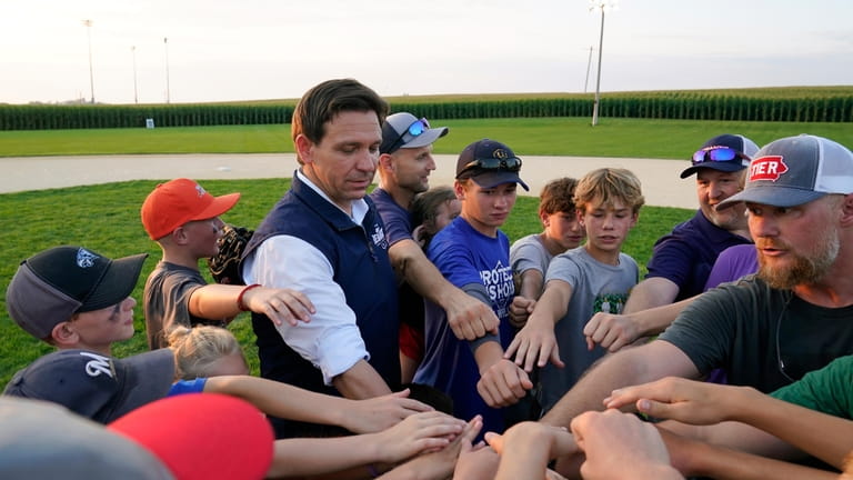 Republican presidential candidate Florida Gov. Ron DeSantis interacts with local...