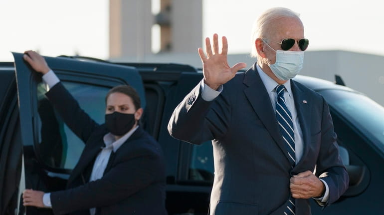 Former Vice President Joe Biden waves as he walks to...