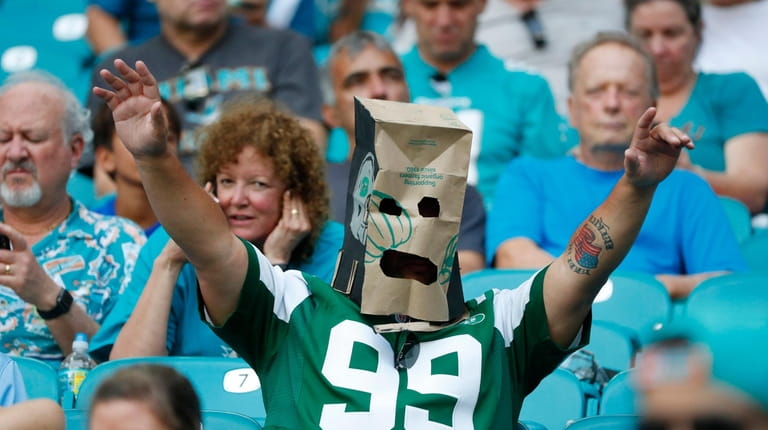 A New York Jets fan wears a paper bag after...