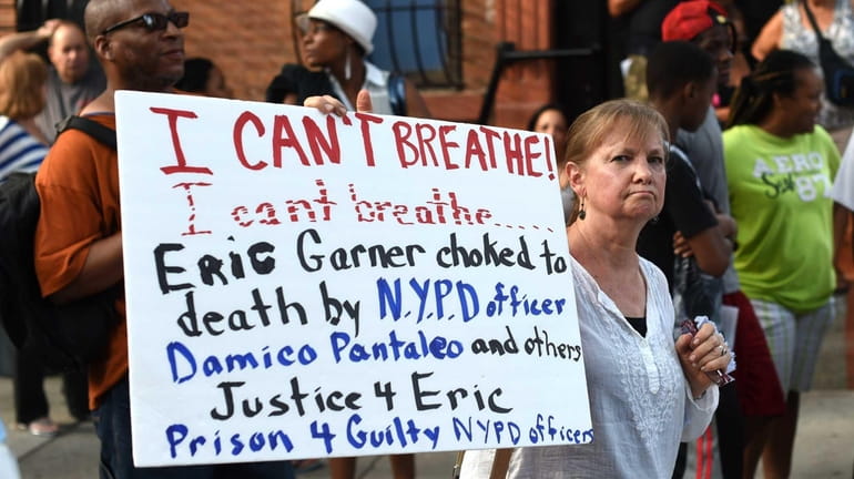 Demonstrators gather outside the funeral service for Eric Garner at...