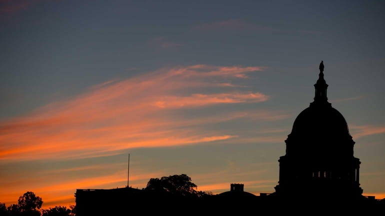 The Capitol Dome is silhouetted by the sunrise. (Sept. 15,...