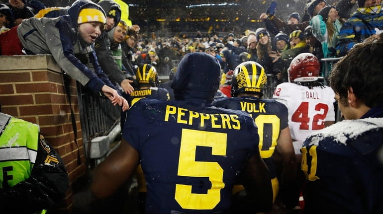 Jabrill Peppers of the Michigan Wolverines leaves the field after...