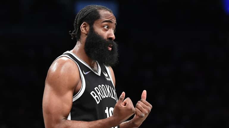 Nets guard James Harden gestures to a referee in the...