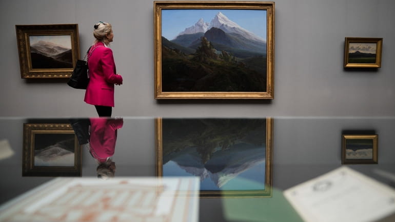 A woman looks to Caspa David Friedrich's painting 'The Watzmann'...
