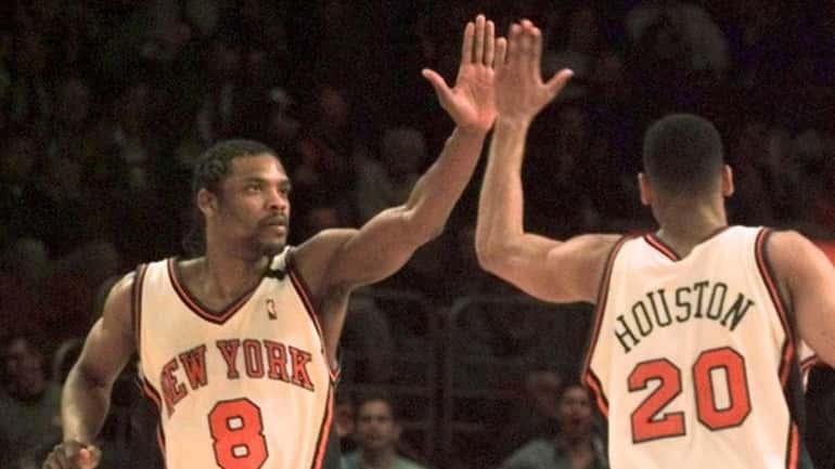 New York Knicks' Latrell Sprewell high-fives with teammate Allan Houston...