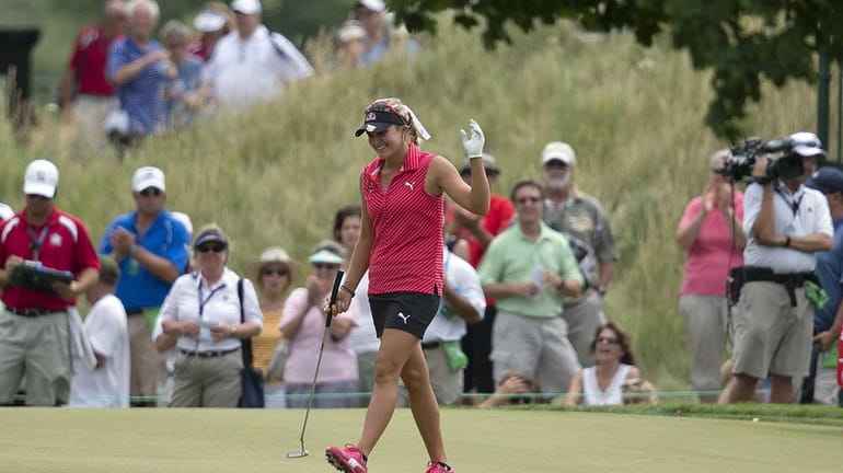 Lexi Thompson reacts after sinking a putt for birdie on...