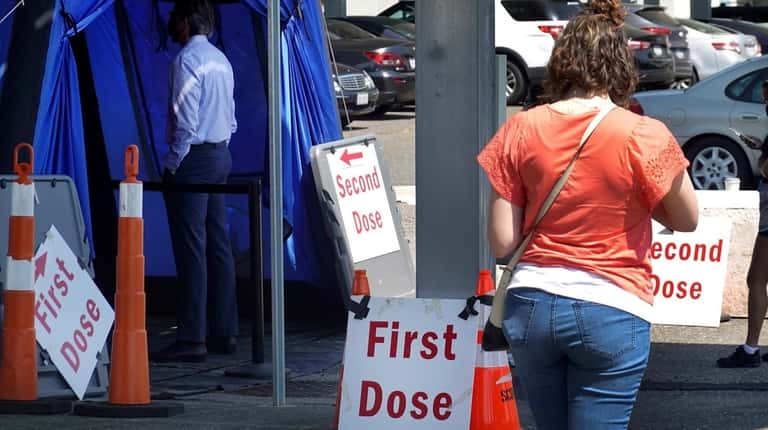 Two separate lines for people seeking first or second doses...