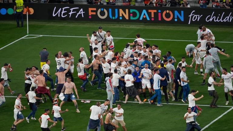Sevilla players celebrate with fans after winning the Europa League...