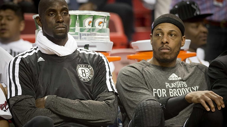 Nets' Kevin Garnett and Paul Pierce watch in the fourth...