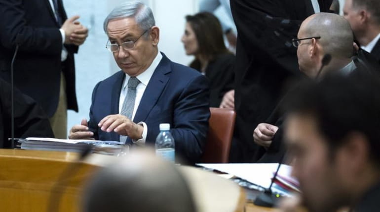 Israeli Prime Minister Benjamin Netanyahu, center left, and unidentified defense...