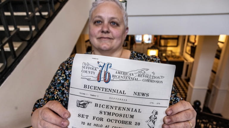 Babylon Town Historian Mary Cascone holds a copy of a publication...