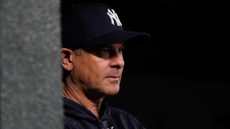 Yankees manager Aaron Boone looks on from the dugout during...