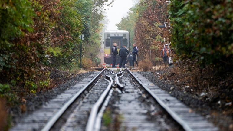 Police work the scene on the LIRR tracks Monday. 