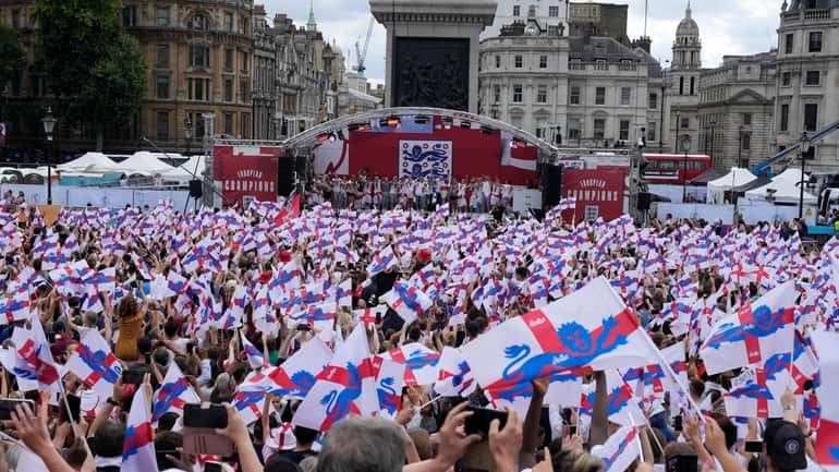 England players celebrate on stage at an event at Trafalgar...
