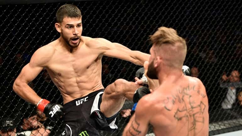 Yair Rodriguez battles Jeremy Stephens in their featherweight bout during...
