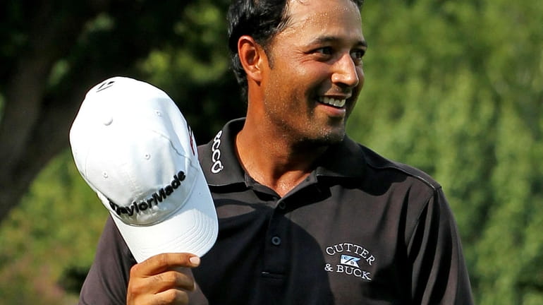 Arjun Atwal reacts on the 18th hole after winning the...