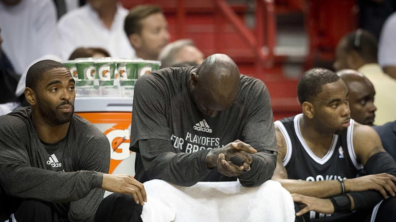 Kevin Garnett and teammates Alan Anderson, left, and Marcus Thornton...