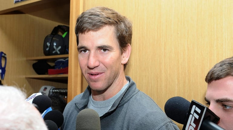 Eli Manning, quarterback for the New York Giants, speaks with...