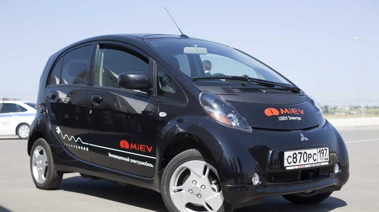 A 2012 Mitsubishi iMiEV is charged in Mineola. (July 14,...