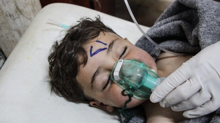A child receives treatment after a chemical attack in northern...