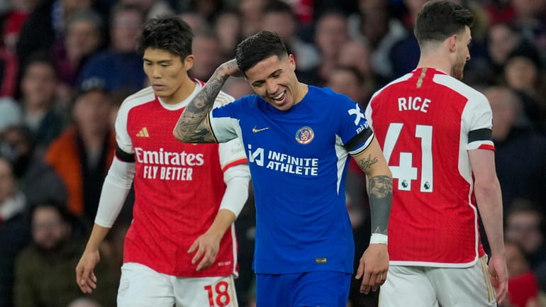 Chelsea's Enzo Fernandez, center, reacts after Arsenal's Leandro Trossard scoring...