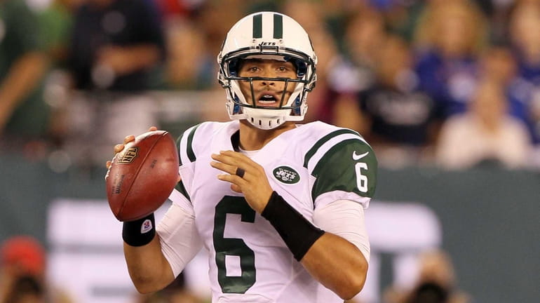 Mark Sanchez looks to pass against the Giants at MetLife...
