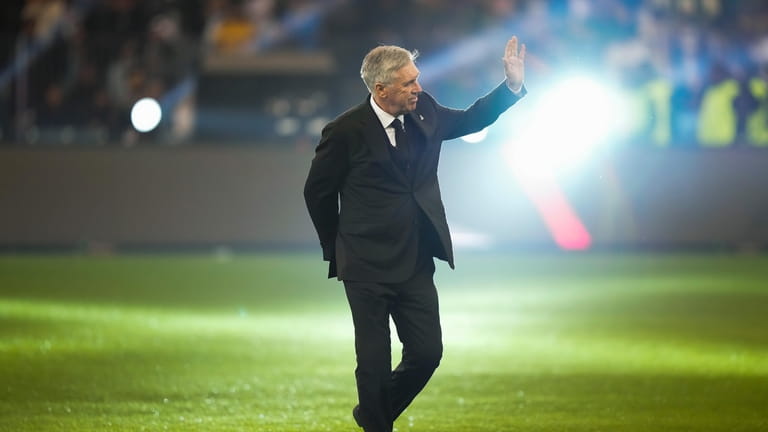 Real Madrid's head coach Carlo Ancelotti waves before the final...