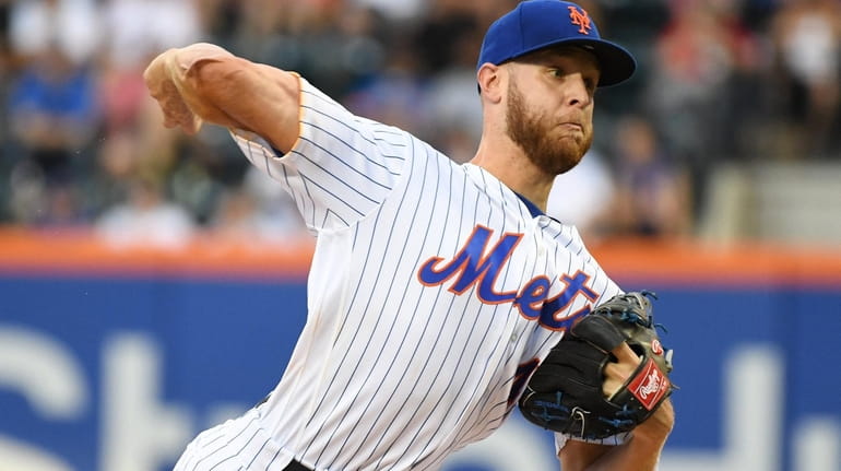 New York Mets starting pitcher Zack Wheeler delivers a pitch...