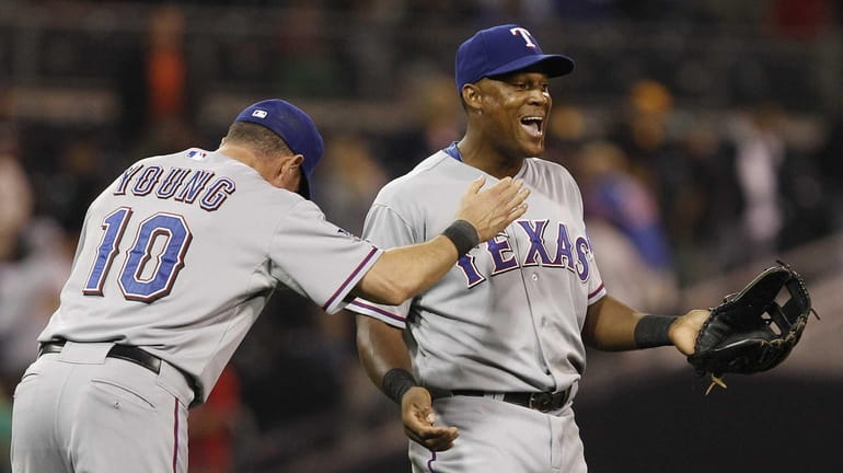 Texas Rangers' Adrian Beltre, right, and Michael Young celebrate after...