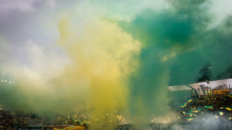 Smoke hangs over the field before the French League One...