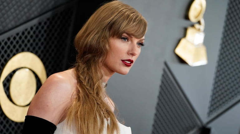 Taylor Swift arrives at the 66th annual Grammy Awards on...