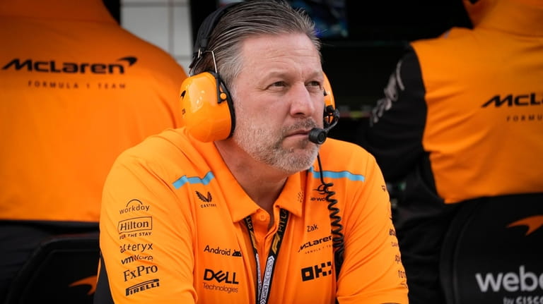 McLaren chief Zak Brown looks at the garages during a...