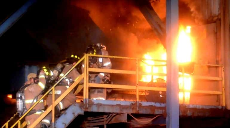 Firefighters battle a blaze at Gershow Recycling in Medford around...