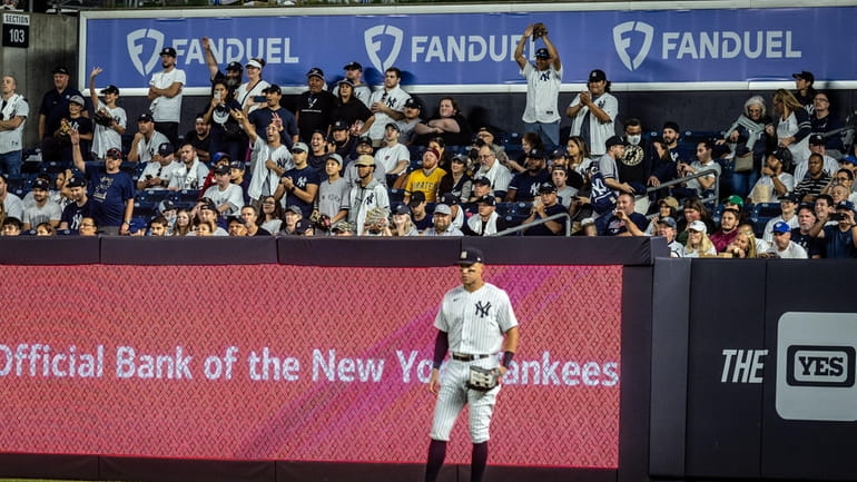  Yankees fans cheer Aaron Judge as he stands in the outfield during...