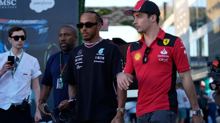 Mercedes driver Lewis Hamilton of Britain, left, and Ferrari driver...