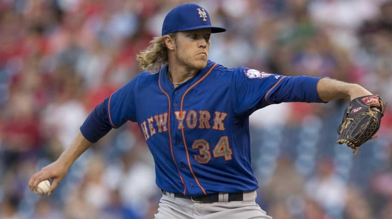 Noah Syndergaard of the New York Mets throws a pitch...