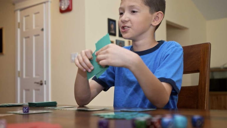 Devon Roth, 9, plays his father in a Pokemon battle....