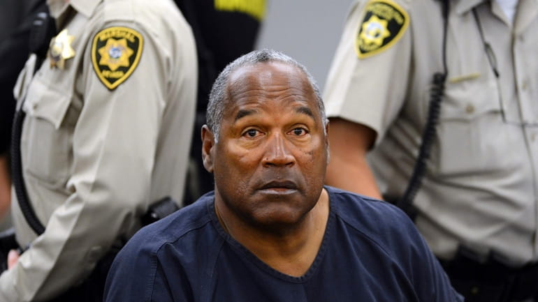 In this May 14, 2013, file photo, O.J. Simpson sits...