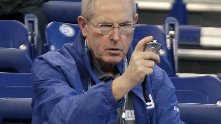 Giants head coach Tom Coughlin checks his stop watch as...
