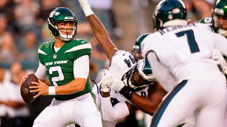 New York Jets' Zach Wilson looks to pass during the...