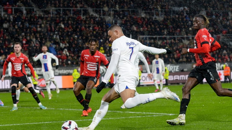 PSG's Kylian Mbappe kicks the ball during the League One...