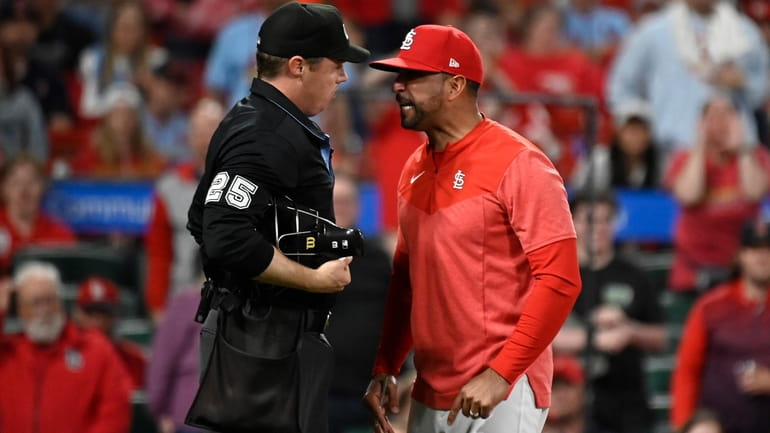 St. Louis Cardinals manager Oliver Marmol, right, argues a call...