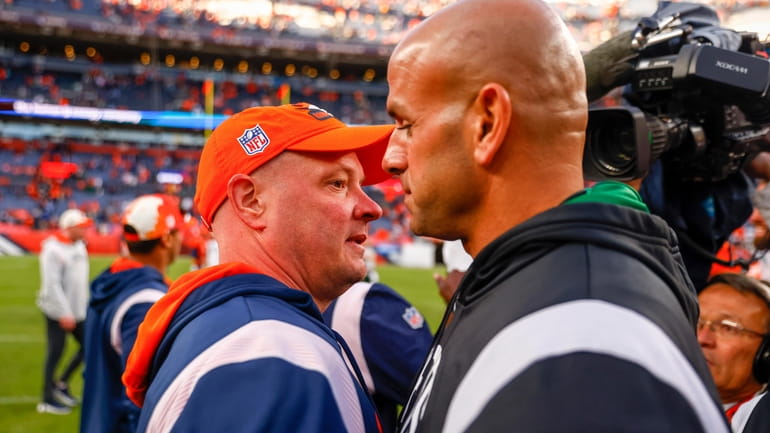 Nathaniel Hackett of the Denver Broncos talks with Robert Saleh...